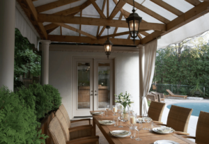 An outdoor dining area next to a large garden door. 